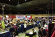 Dayton Hamvention show floor with vendors displaying ham radio equipment and participants exploring gear and treasures.